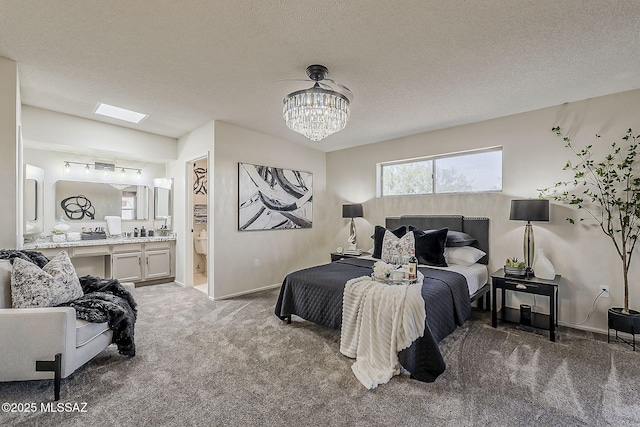 2756 S Via Del Bac, Green Valley, AZ 85622 - carpeted bedroom with a chandelier, a textured ceiling, baseboards, and ensuite bathroom