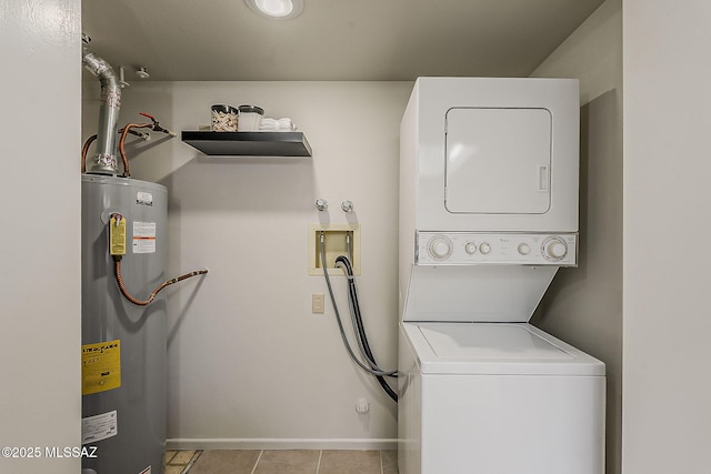 2756 S Via Del Bac, Green Valley, AZ 85622 - clothes washing area featuring water heater, stacked washing machine and dryer, baseboards, and light tile patterned flooring