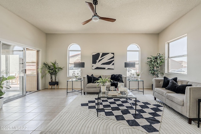2756 S Via Del Bac, Green Valley, AZ 85622 - living room featuring healthy amount of natural light, ceiling fan, light tile patterned flooring, and a textured ceiling