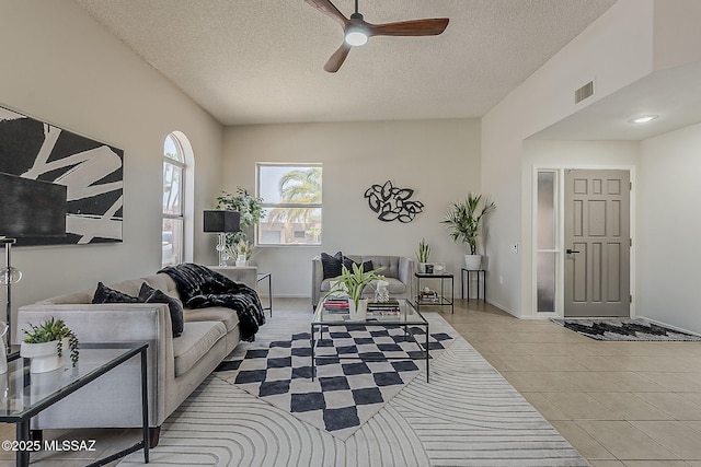 2756 S Via Del Bac, Green Valley, AZ 85622 - living room with a ceiling fan, a textured ceiling, light tile patterned floors, and baseboards