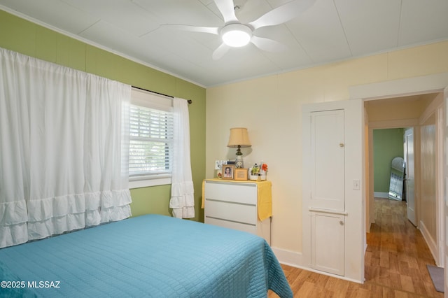 24 Black Knob, Bisbee, AZ 85603 - bedroom featuring light wood-style flooring, crown molding, a ceiling fan, and baseboards