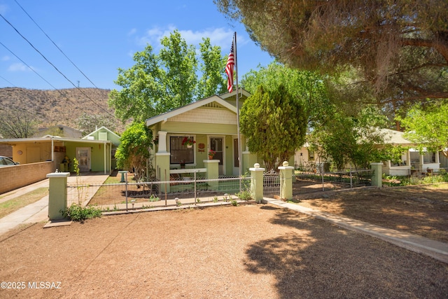24 Black Knob, Bisbee, AZ 85603 - view of front of property with a porch, a fenced front yard, a gate, and a mountain view