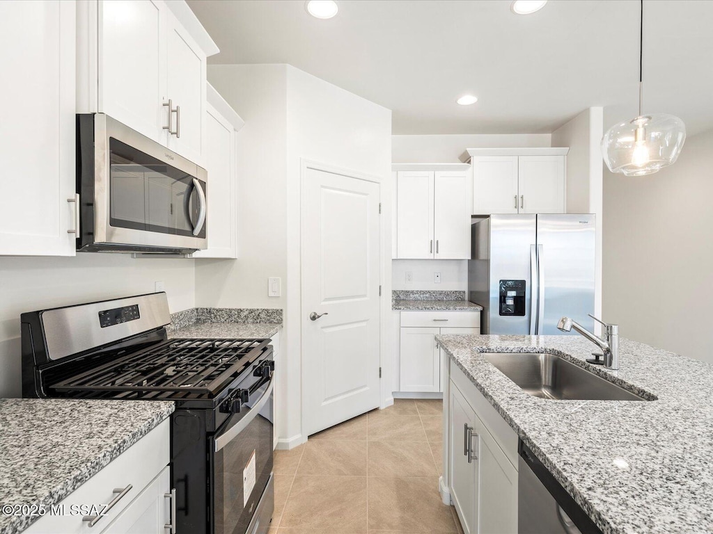 6806 E Via Del Cantillo, Tucson, AZ 85756 - kitchen with stainless steel appliances, a sink, white cabinetry, light tile patterned floors, and recessed lighting