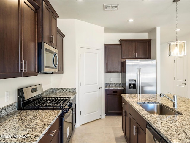6818 E Via Del Cantillo, Tucson, AZ 85756 - kitchen featuring appliances with stainless steel finishes, a sink, dark brown cabinets, light tile patterned floors, and light stone counters