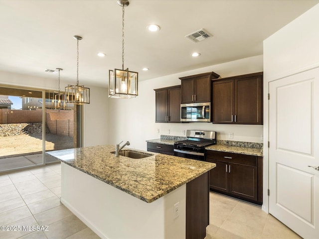 6818 E Via Del Cantillo, Tucson, AZ 85756 - kitchen with appliances with stainless steel finishes, a sink, a chandelier, light stone counters, and light tile patterned floors