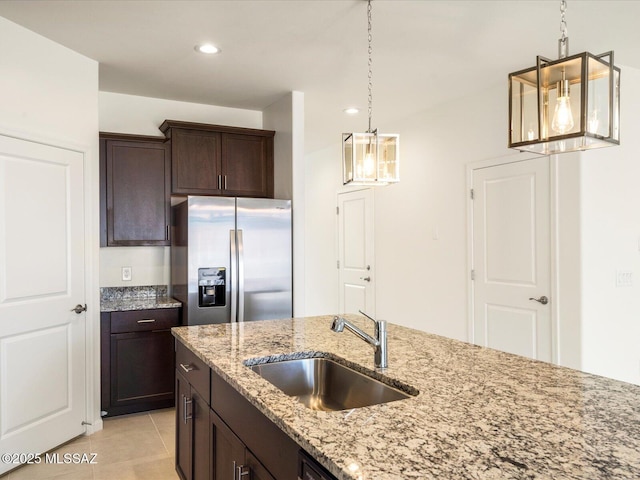 6818 E Via Del Cantillo, Tucson, AZ 85756 - kitchen with stainless steel fridge with ice dispenser, a sink, dark brown cabinetry, decorative light fixtures, and light tile patterned floors