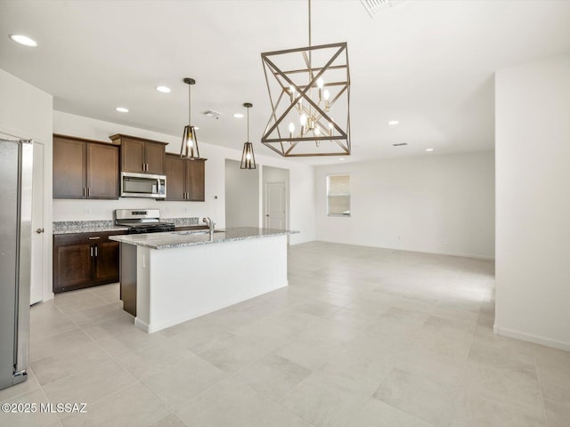 4743 E Julian Wash Dr, Tucson, AZ 85706 - kitchen with stainless steel appliances, a sink, recessed lighting, an island with sink, and dark brown cabinetry