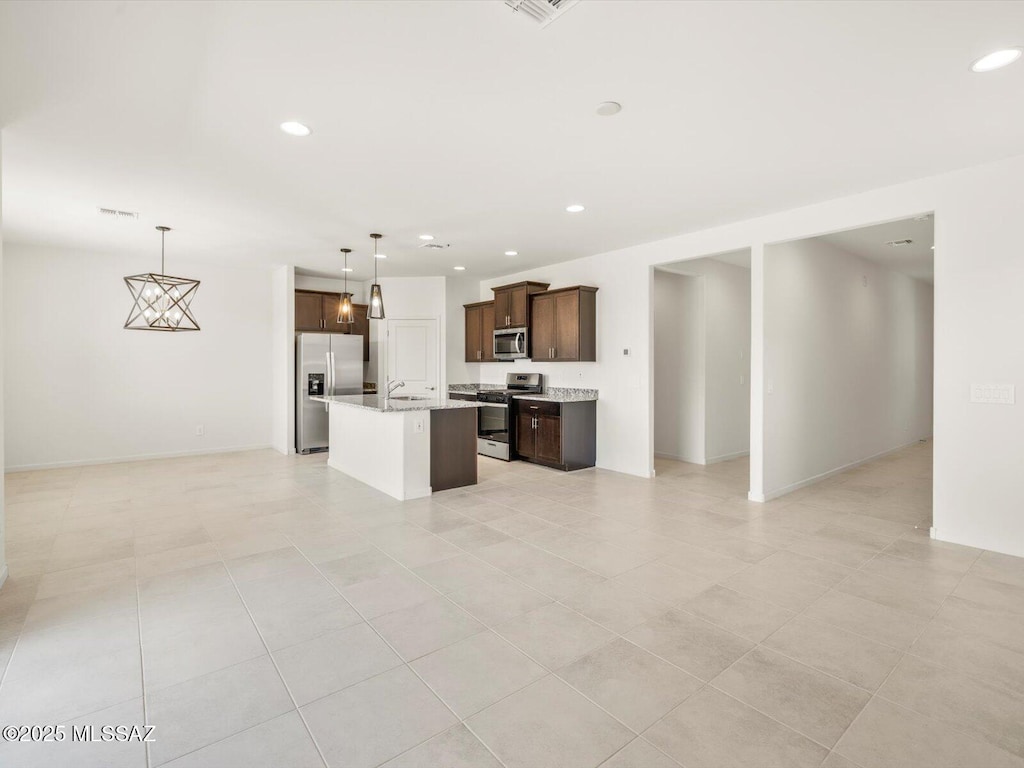 4743 E Julian Wash Dr, Tucson, AZ 85706 - unfurnished living room with recessed lighting and light tile patterned floors