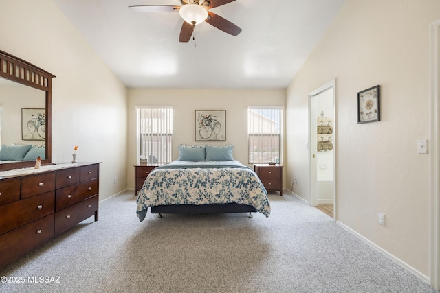 9429 N Elan Ln, Tucson, AZ 85742 - bedroom with light colored carpet, lofted ceiling, baseboards, and ceiling fan
