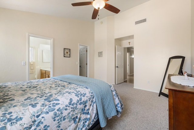 9429 N Elan Ln, Tucson, AZ 85742 - carpeted bedroom with ensuite bathroom, baseboards, and ceiling fan
