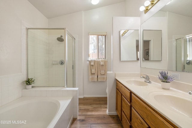 9429 N Elan Ln, Tucson, AZ 85742 - full bath featuring wood finished floors, a stall shower, a garden tub, and double vanity