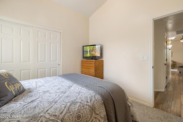 9429 N Elan Ln, Tucson, AZ 85742 - bedroom with a closet, lofted ceiling, baseboards, and wood finished floors