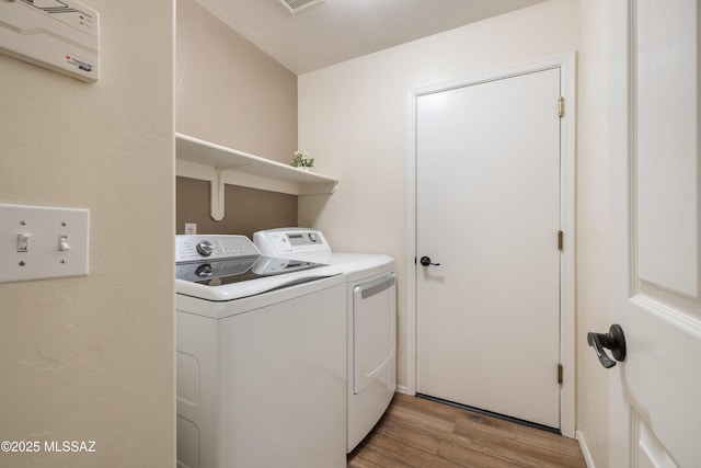 9429 N Elan Ln, Tucson, AZ 85742 - laundry room featuring washer and dryer and light wood finished floors