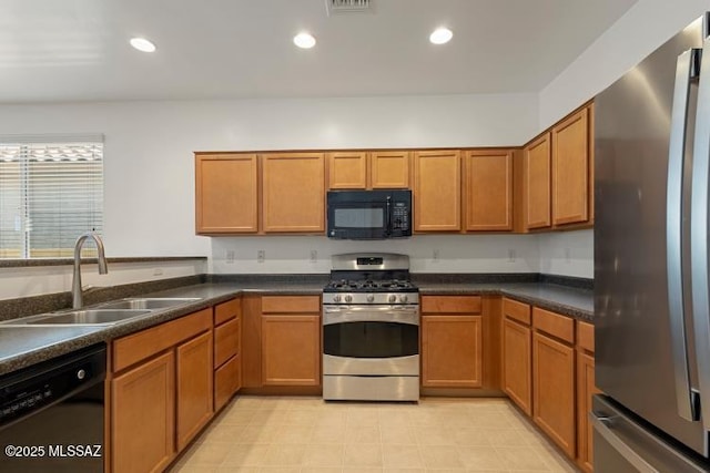 6902 W Leeward Cove Way, Tucson, AZ 85757 - kitchen with black appliances, a sink, brown cabinetry, and recessed lighting