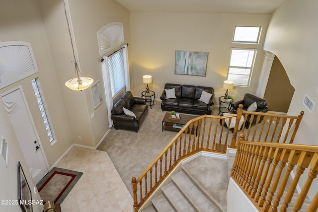 368 W Sacaton Canyon Dr, Oro Valley, AZ 85755 - carpeted living area featuring a high ceiling, tile patterned floors, and stairs
