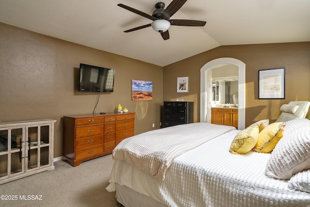 368 W Sacaton Canyon Dr, Oro Valley, AZ 85755 - bedroom featuring light colored carpet, arched walkways, lofted ceiling, ceiling fan, and ensuite bath