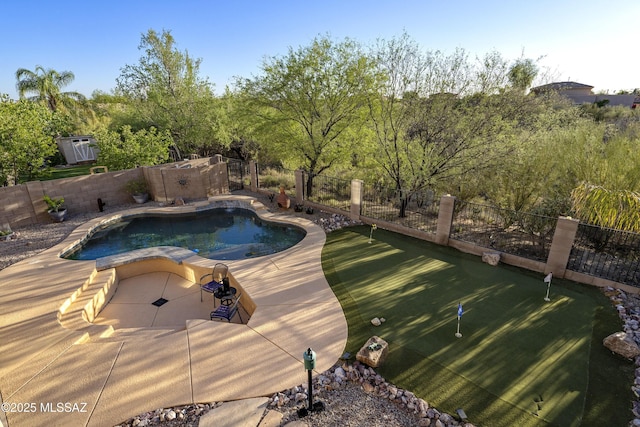 368 W Sacaton Canyon Dr, Oro Valley, AZ 85755 - view of pool with a putting area and a fenced backyard