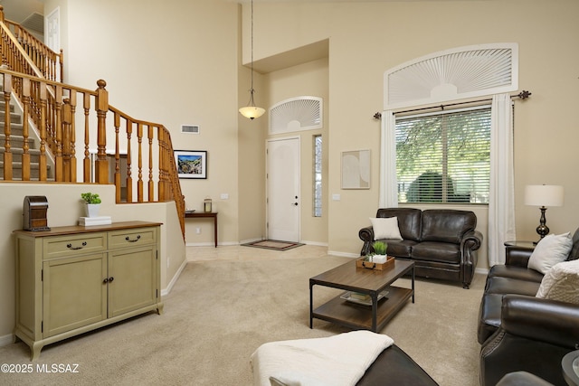 368 W Sacaton Canyon Dr, Oro Valley, AZ 85755 - living area featuring stairs, light colored carpet, and a high ceiling