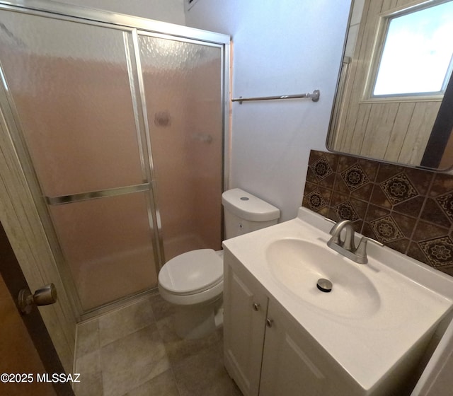 6509 E 39th St, Tucson, AZ 85730 - bathroom featuring a shower stall, toilet, tasteful backsplash, and vanity