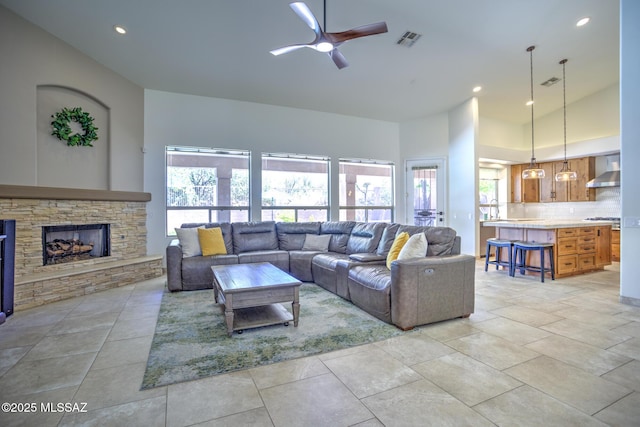 218 W Milbrae Springs Dr, Oro Valley, AZ 85755 - living room with a ceiling fan, high vaulted ceiling, a stone fireplace, and recessed lighting