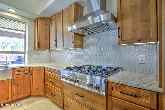 218 W Milbrae Springs Dr, Oro Valley, AZ 85755 - kitchen featuring wall chimney exhaust hood, stainless steel gas stovetop, decorative backsplash, and brown cabinetry