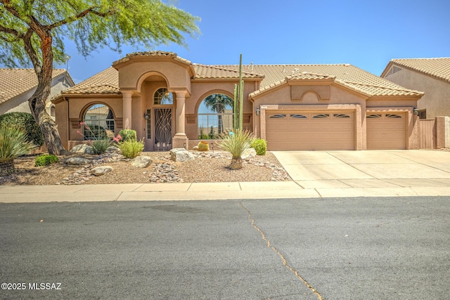 218 W Milbrae Springs Dr, Oro Valley, AZ 85755 - mediterranean / spanish house featuring a garage, stucco siding, concrete driveway, and a tiled roof