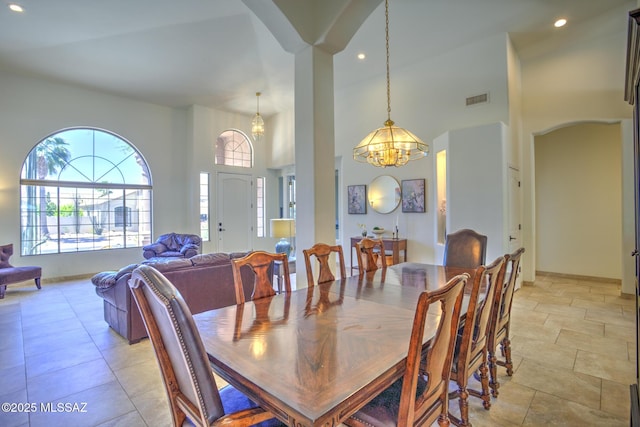 218 W Milbrae Springs Dr, Oro Valley, AZ 85755 - dining area with a chandelier, recessed lighting, arched walkways, and a high ceiling