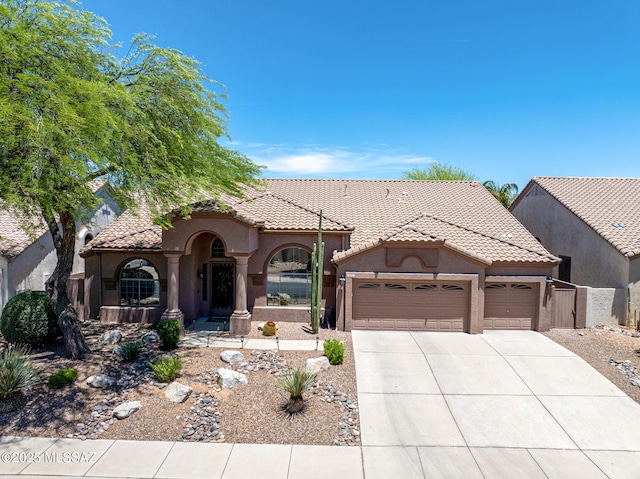 218 W Milbrae Springs Dr, Oro Valley, AZ 85755 - mediterranean / spanish-style house featuring a garage, driveway, stucco siding, and a tile roof