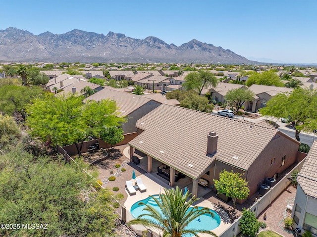 218 W Milbrae Springs Dr, Oro Valley, AZ 85755 - aerial perspective of suburban area with a pool area and a mountain backdrop