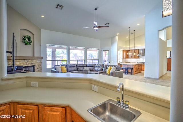 218 W Milbrae Springs Dr, Oro Valley, AZ 85755 - kitchen with a sink, wall chimney exhaust hood, open floor plan, ceiling fan, and healthy amount of natural light