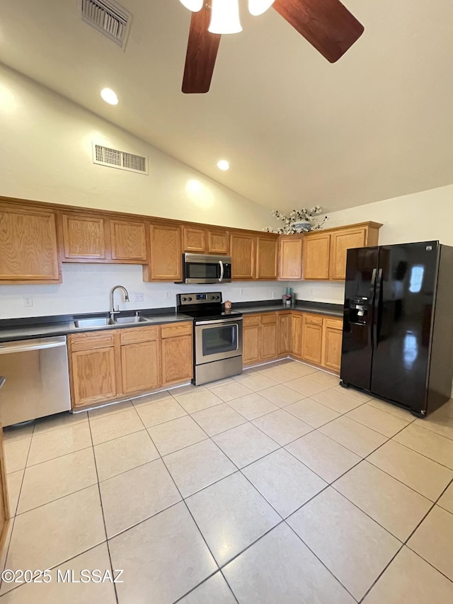115 W Birdman Dr, Tucson, AZ 85705 - kitchen featuring stainless steel appliances, a sink, a ceiling fan, dark countertops, and light tile patterned floors