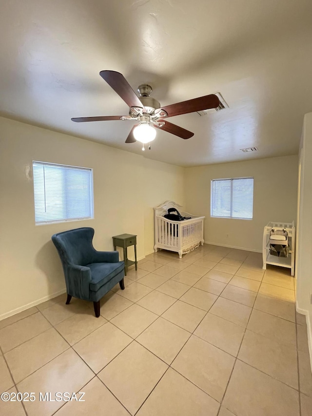115 W Birdman Dr, Tucson, AZ 85705 - bedroom with light tile patterned floors, baseboards, and ceiling fan