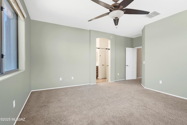 2247 W Night Air Ln, Tucson, AZ 85741 - unfurnished bedroom with carpet, baseboards, arched walkways, and ceiling fan