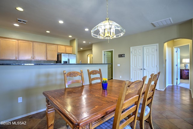 11113 N Rams Horn Trl N, Oro Valley, AZ 85737 - dining area with arched walkways, a chandelier, recessed lighting, and baseboards