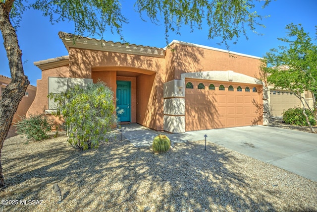 11113 N Rams Horn Trl N, Oro Valley, AZ 85737 - view of front of house with stucco siding, an attached garage, and driveway