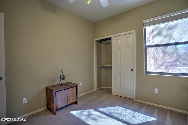 11113 N Rams Horn Trl N, Oro Valley, AZ 85737 - unfurnished bedroom with carpet flooring, a closet, baseboards, and a ceiling fan