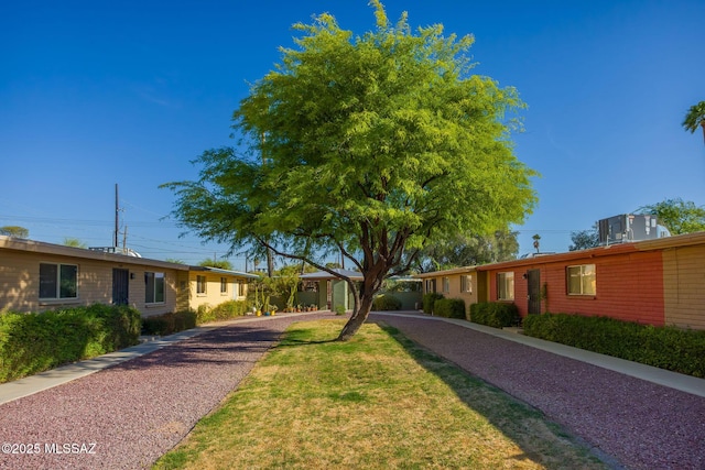 3025 E Blacklidge Dr, Tucson, AZ 85716 - view of home's community featuring gravel driveway and a lawn