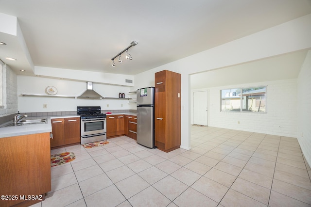 3025 E Blacklidge Dr, Tucson, AZ 85716 - kitchen featuring stainless steel appliances, open shelves, wall chimney exhaust hood, a sink, and light tile patterned flooring