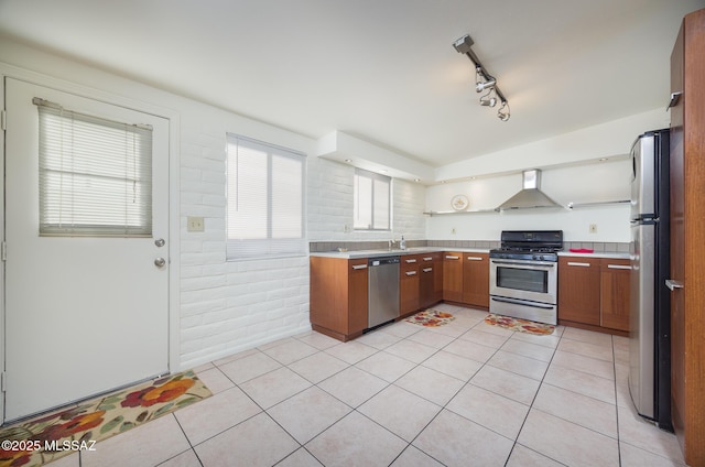 3025 E Blacklidge Dr, Tucson, AZ 85716 - kitchen with appliances with stainless steel finishes, wall chimney range hood, light countertops, open shelves, and light tile patterned flooring