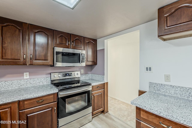 6158 E Calle Aurora, Tucson, AZ 85711 - kitchen with appliances with stainless steel finishes, light countertops, and dark brown cabinetry