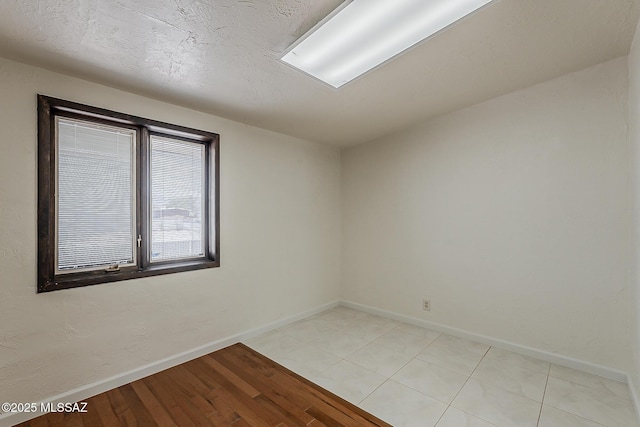 6158 E Calle Aurora, Tucson, AZ 85711 - spare room featuring baseboards and light wood-style floors