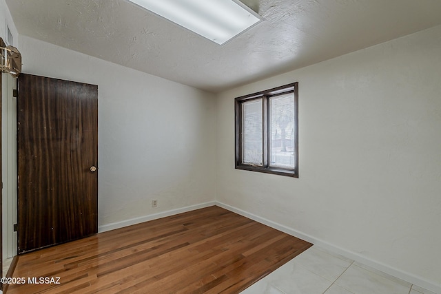 6158 E Calle Aurora, Tucson, AZ 85711 - spare room with baseboards and wood finished floors