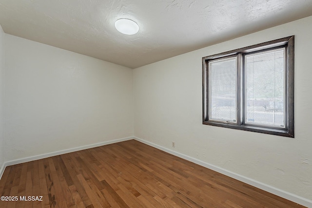 6158 E Calle Aurora, Tucson, AZ 85711 - empty room featuring wood finished floors and baseboards