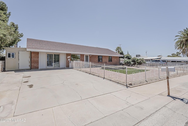 6158 E Calle Aurora, Tucson, AZ 85711 - ranch-style house featuring brick siding, fence, and driveway