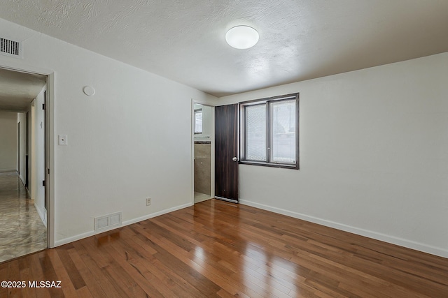 6158 E Calle Aurora, Tucson, AZ 85711 - unfurnished room featuring wood-type flooring and baseboards