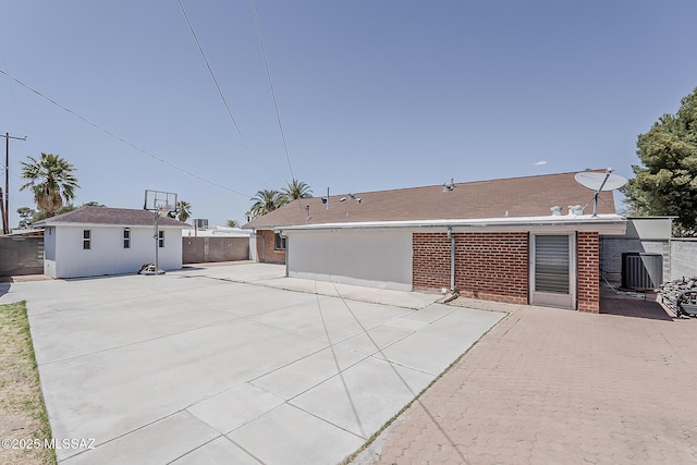 6158 E Calle Aurora, Tucson, AZ 85711 - back of house with brick siding, fence, a patio area, central AC, and an outdoor structure