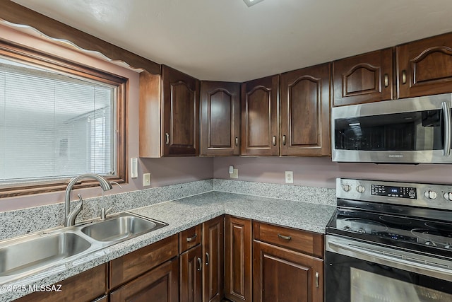 6158 E Calle Aurora, Tucson, AZ 85711 - kitchen featuring stainless steel appliances, a sink, light countertops, and dark brown cabinetry
