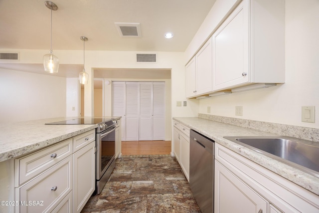 9846 E 2nd St, Tucson, AZ 85748 - kitchen with appliances with stainless steel finishes, decorative light fixtures, white cabinetry, recessed lighting, and dark stone finish floors