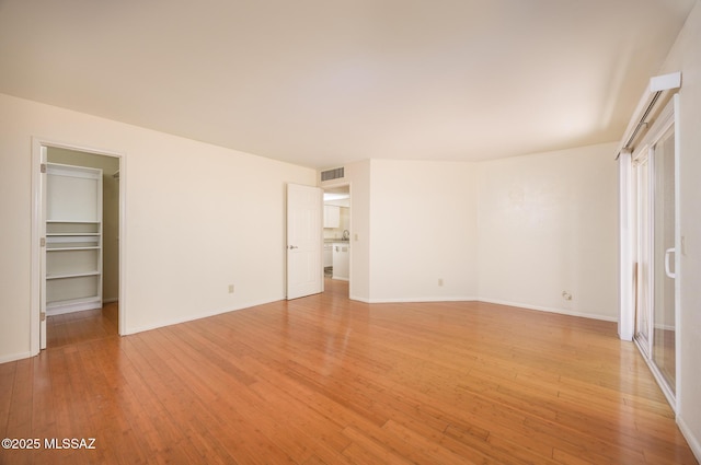9846 E 2nd St, Tucson, AZ 85748 - unfurnished bedroom with light wood-style flooring, a spacious closet, and baseboards