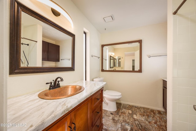 9846 E 2nd St, Tucson, AZ 85748 - full bathroom featuring vanity, toilet, baseboards, and a shower